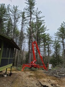 Red aerial Lift Bucket done for the day folded to the ground.